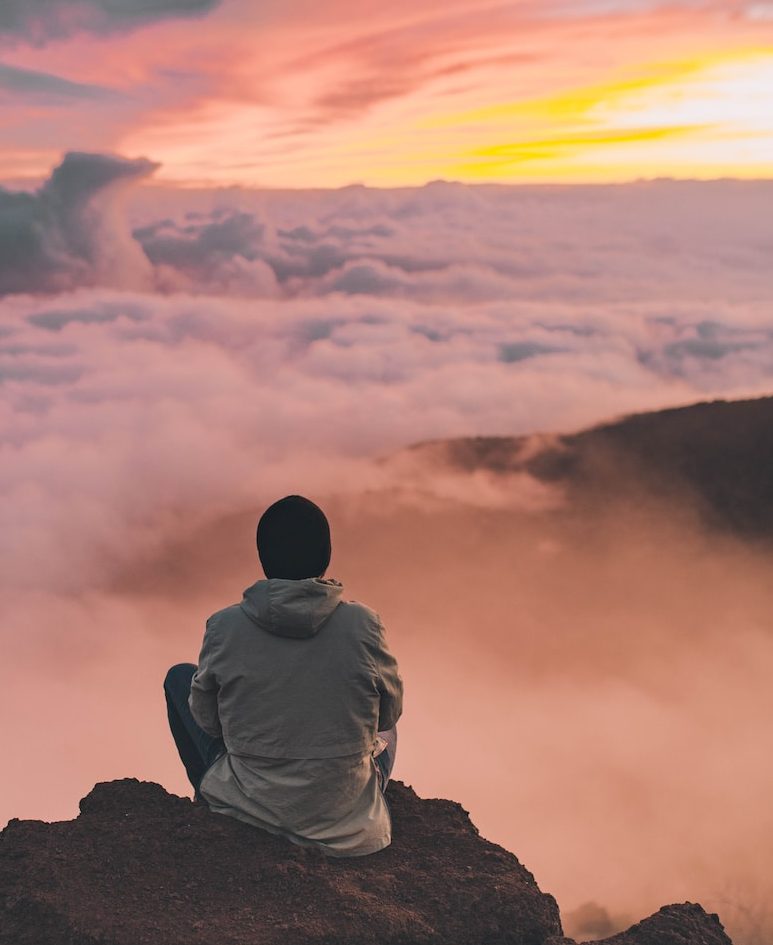 man sitting on cliff